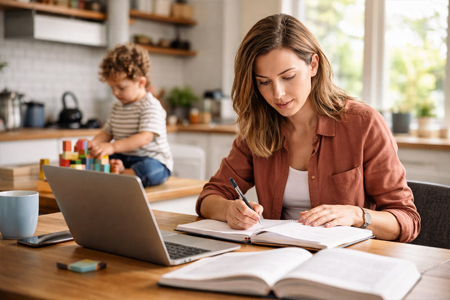 Adult learner reviewing coursework while balancing family responsibilities