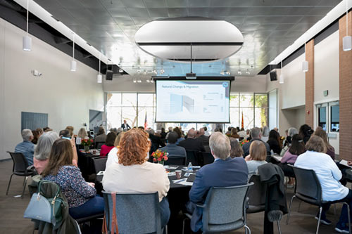 Event attendees observing presentation