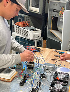 HVAC Student working on circuit board