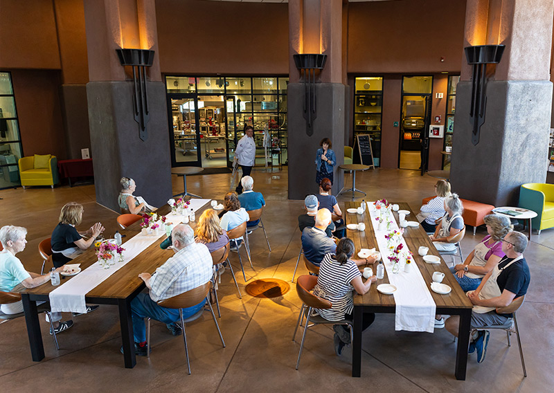 Community gathering around a long table in the Sedona Center