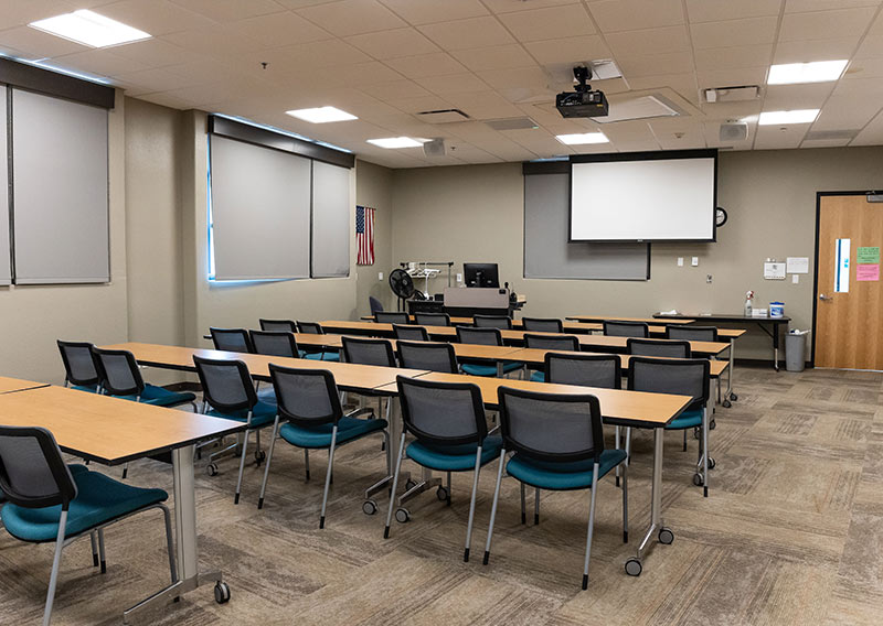 Flexible Sedona Center classroom with tables, chairs and a presentation screen