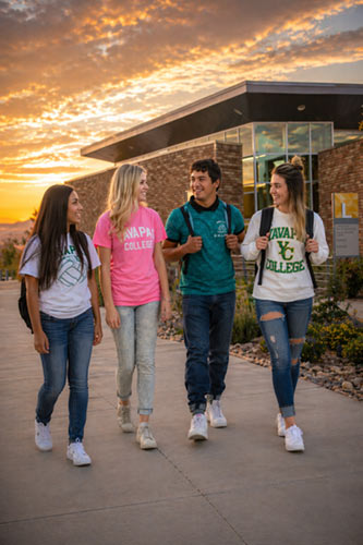Yavapai College students talking on campus walkway during golden hour