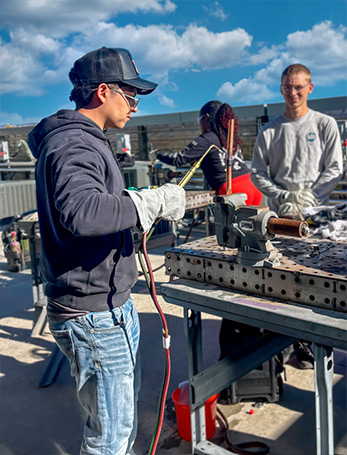 Stuent working a weld