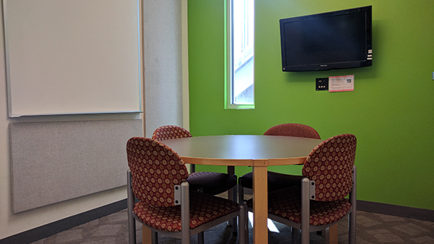 study room with table, four chairs, and monitor