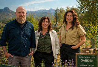 Three people in a garden