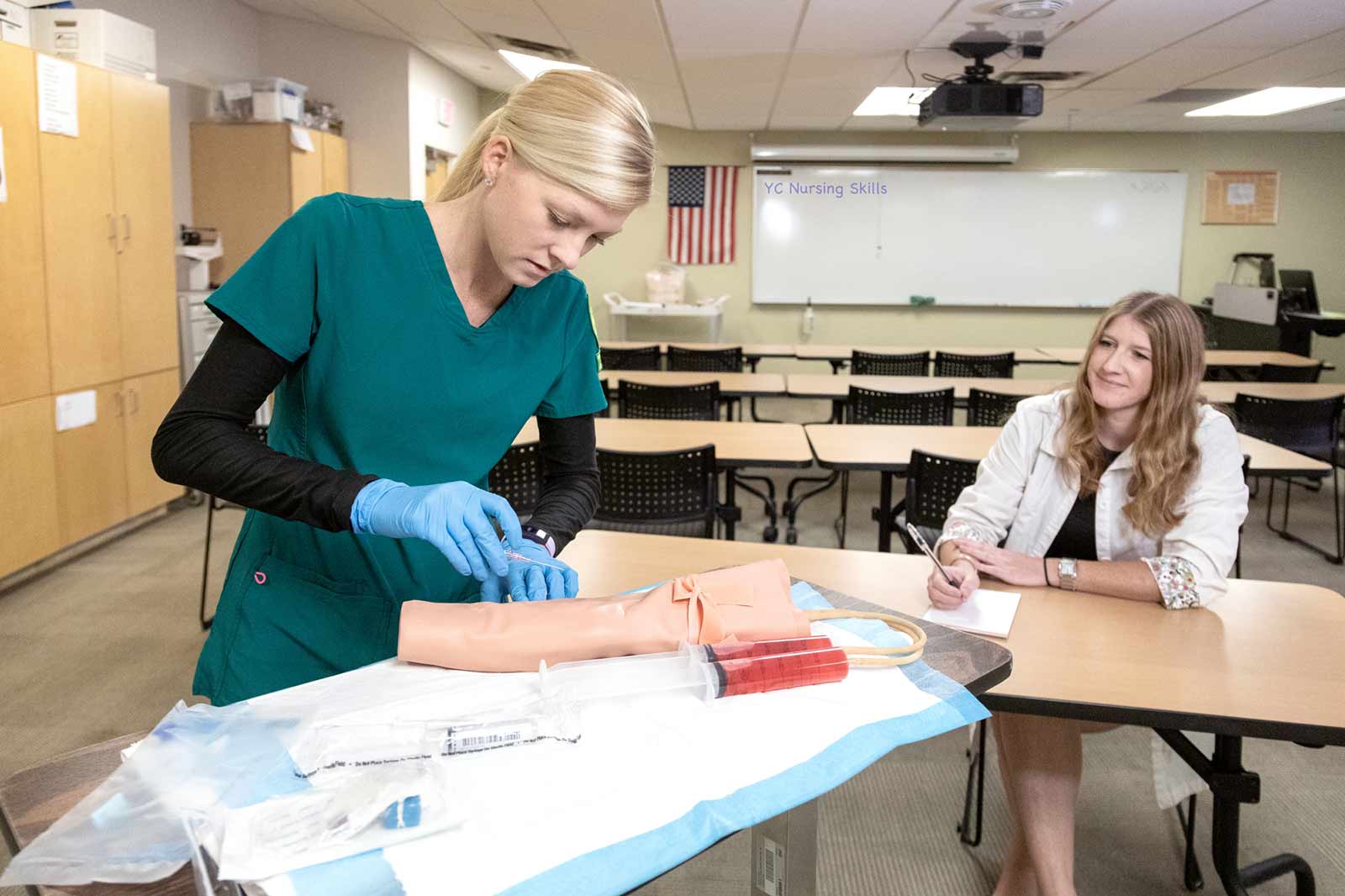 YC Nursing instructor Katie Adams, right, observes nursing student's techniques.