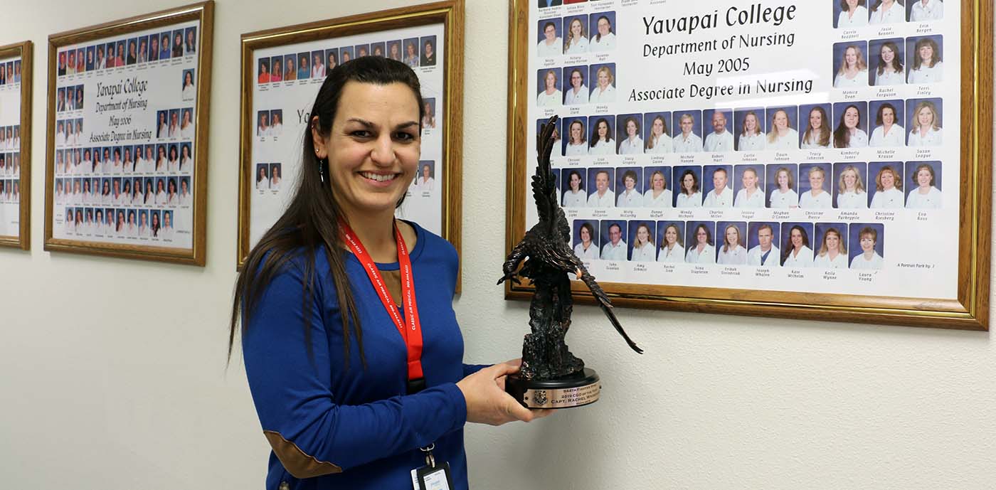 Rachel Whisenand displays her Company Grade Officer of the Year award in the hallway of the YC nursing department.