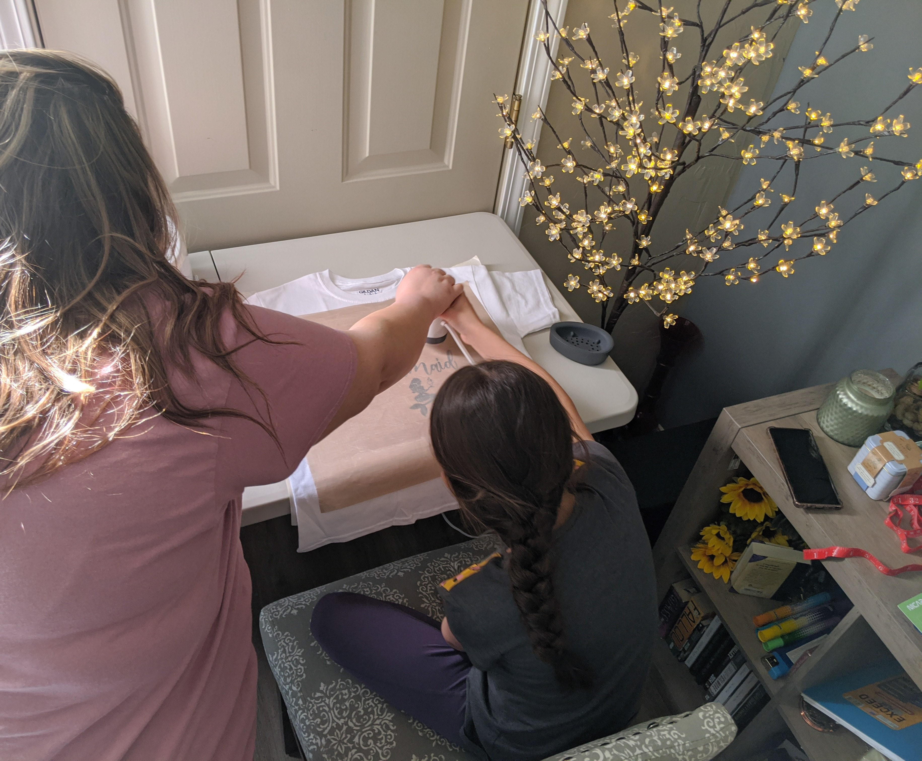 Amanda Schumacher and her 7-year-old student create T-shirts together.