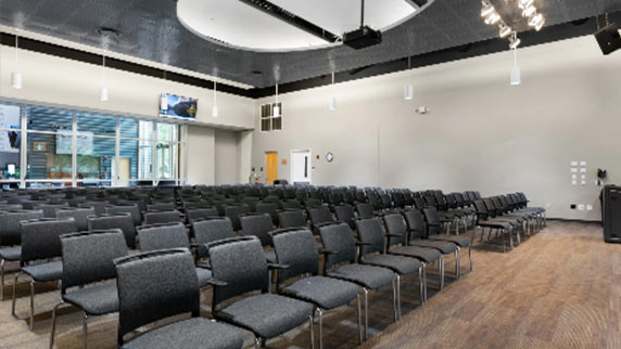 rows of 60+ seats facing the podium